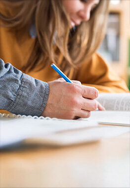 A caucasian high school girl getting help with her homework from her dad