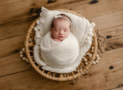 sweet baby girl posed n all cream for her denver newborn photos