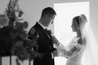 Tayhgen putting on Rylie's boutonniere. 