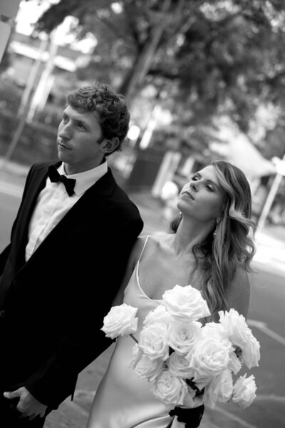 Groom and bride walking down the street during vintage elopement, captured in black and white photography