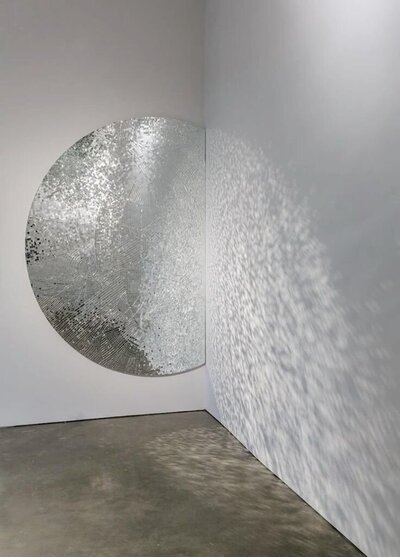 A  circular, reflective wall decoration