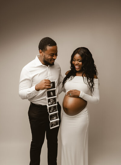 Mother-to-be embracing her pregnancy journey in a beautifully styled maternity studio session in Minneapolis