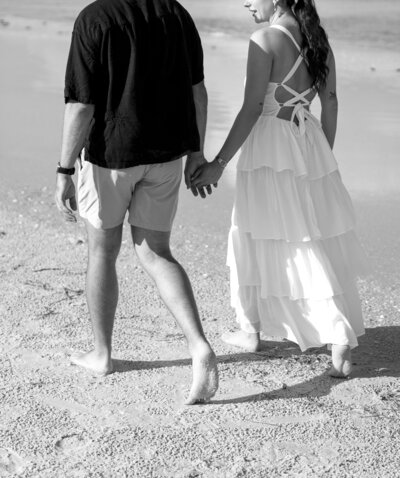 Couple holding hands and walking taken by engagement photography florida