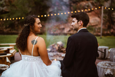 bride and groom hang out by the fire