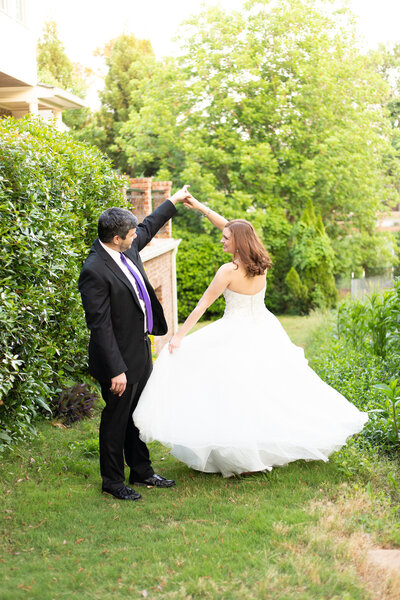 groom twirling bride
