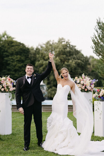 Newly wed couple smiling down the aisle