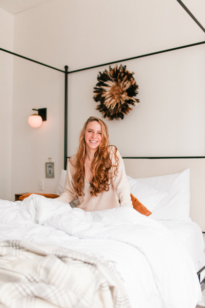 woman laying on bed smiling