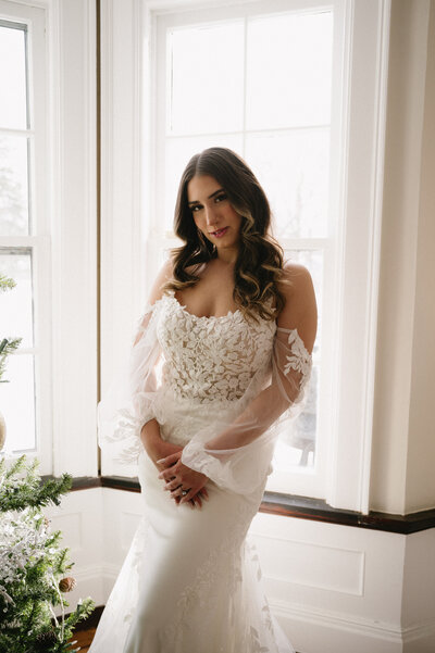 bridal portrait of bride with sopia tolli wedding dress with sleeves at whitehall mansion in brockport ny