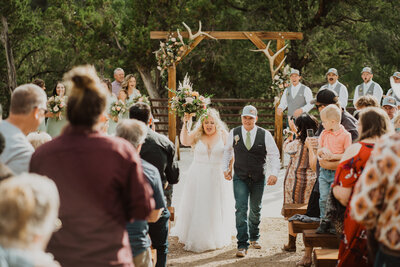 Couple celebrates walking down the aisle after wedding in Nevada.