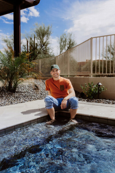 Madison Wetter, local real estate agent, sitting in the living room of a bright and colorful Cave Creek home. 