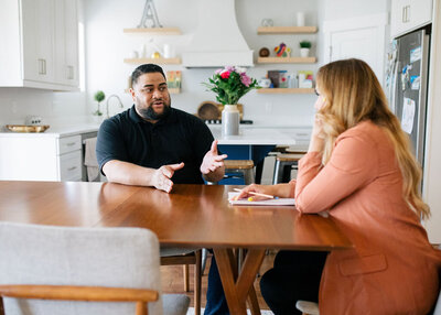 Therapist sitting in a dining room talking with a man