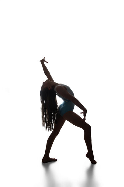 A sassy silhouette pose of a gymnast on a white backdrop in Las Vegas, Nevada