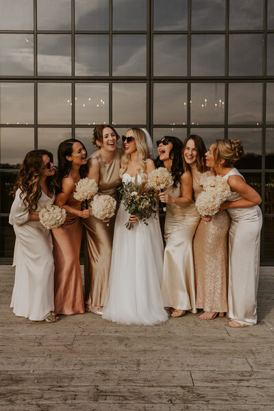 couple bursting into laughter, filled with genuine joy and happiness on their wedding day.