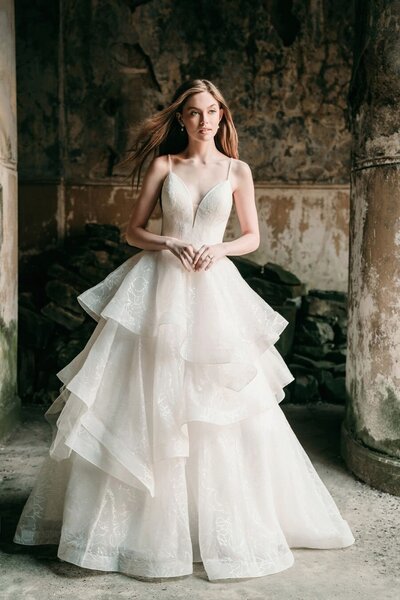 A statement bow and sequined floral tracing emphasize the train of this ballgown.