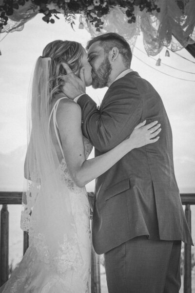 An eloping couple shares their first kiss after saying their vows