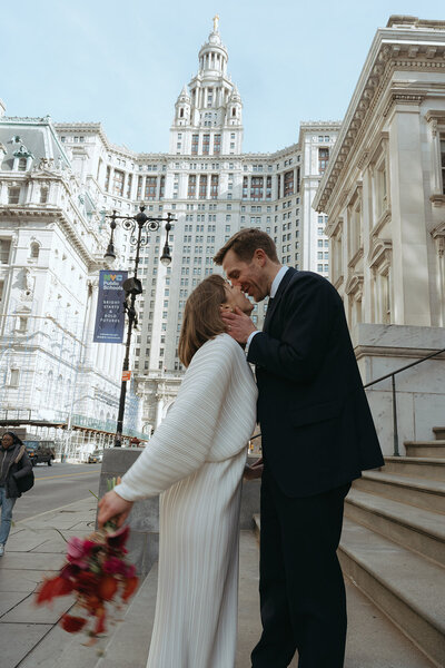 bride and groom kissing at city hall after elopement ceremony shot by Elsie Goodman Photography | NYC Elopement Packages