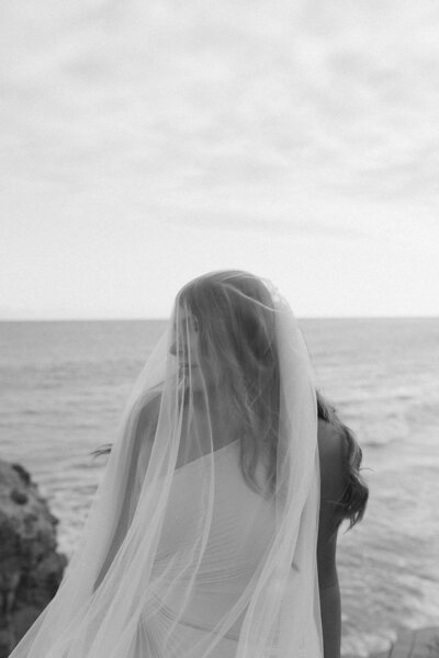 bride with veil on the beach