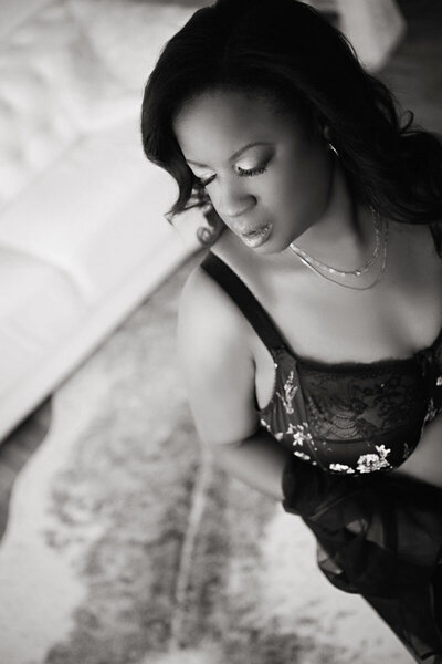 Plus size woman in colorful lingerie set posing on bed