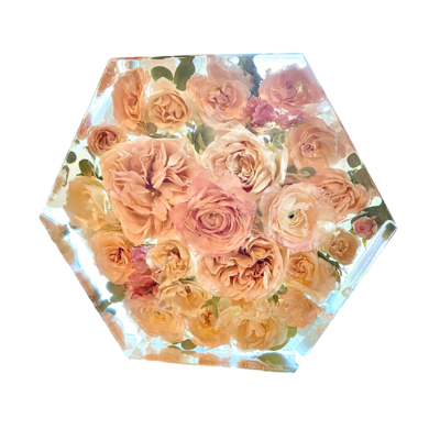 bride and groom sitting out side of LDS temple holding light pink orange and blue bouquet