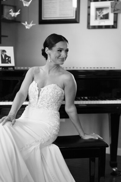 Bride in a satin gown with flowing sleeves walking down a staircase
