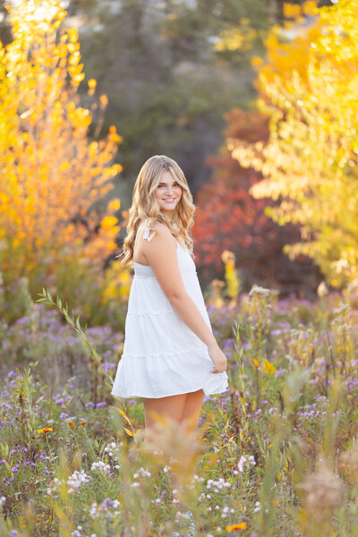 Senior girl twirling in a field at Kathryn Albertson Park in Boise.