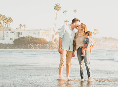 San Diego Family Photographer, couple standing in the water with toddler on mom's hip