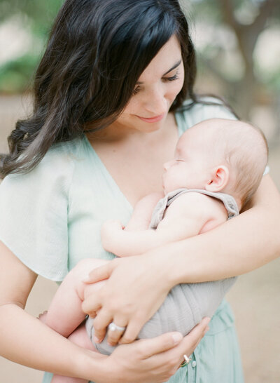 Newborn photography with mom looking lovingly at the baby