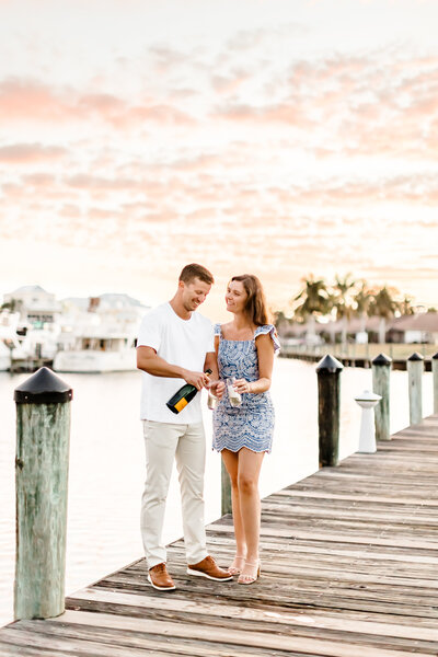 wedding photography miami fl of couple with champagne on a dock
