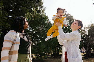 Lesbian Moms playing with 10 month old baby at a park in Hudson Valley, New York