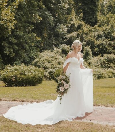 Bride walks holding a flower bouquet