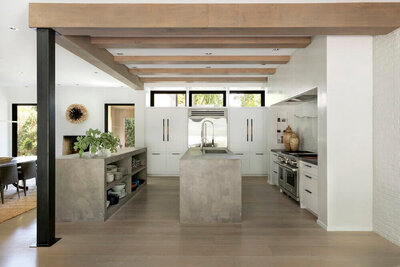 Concrete island with open floating shelves in modern kitchen