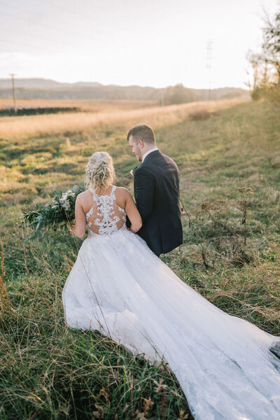 Sacramento Wedding Photographer captures bride and groom walking together after forest wedding