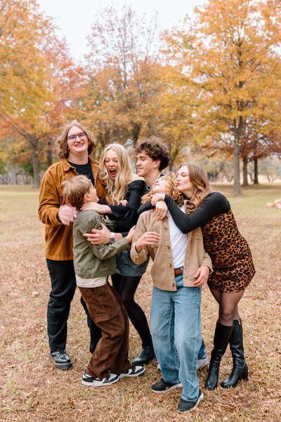 Arkansas family session outdoors during the fall with all siblings messing with each other