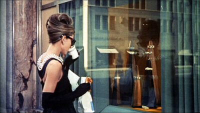 Audrey Hepburn in a classic film scene, inspiring timeless elegance and refined wedding style for Southern garden and estate celebrations