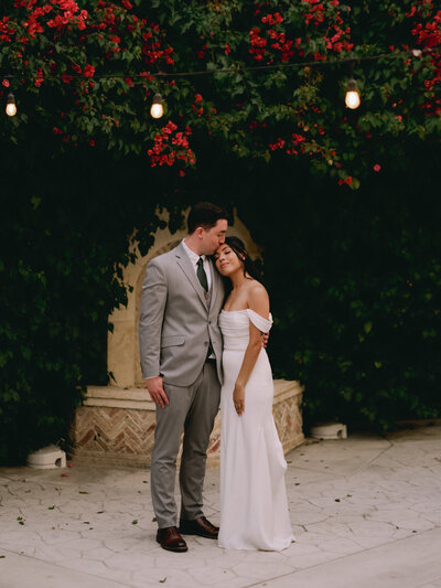 Bride and groom walking through forest