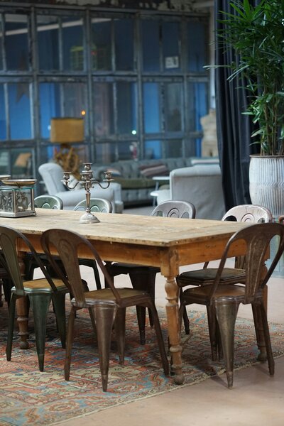 A dinning room with an antique table and interior furniture.