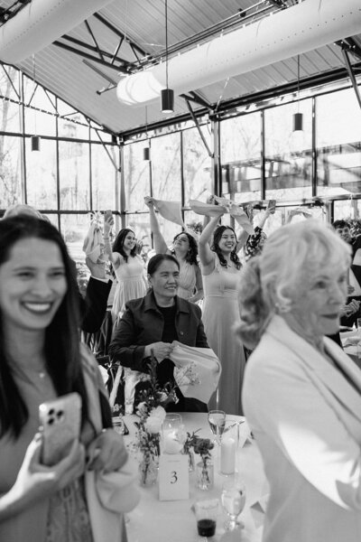wedding guests at a wedding reception celebrating the Mr. and Mrs. entrance