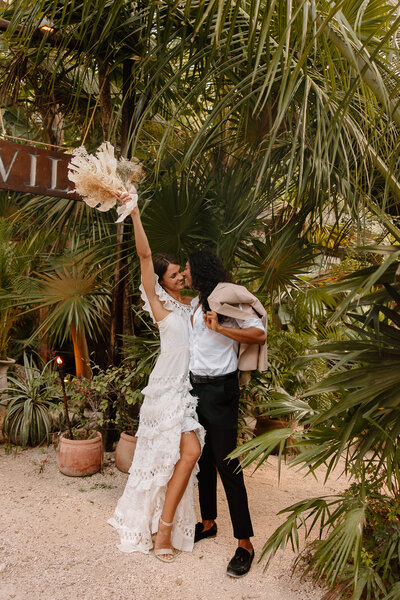 Bride and groom celebrate after they say I do at their mexico wedding.