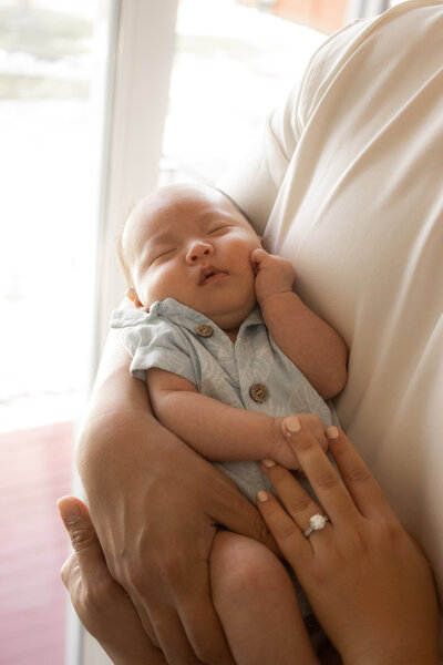 close up of newborn baby boy's hair and ear during a fresh 48 in-hospital session