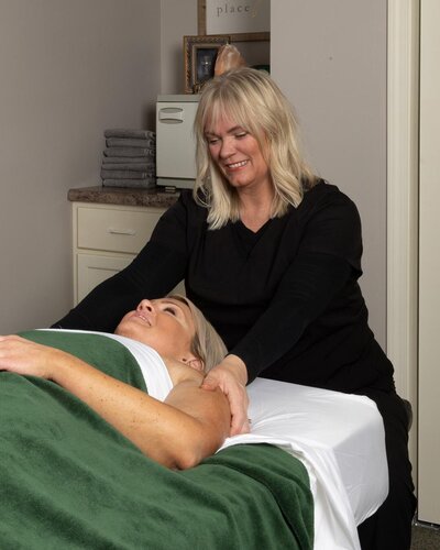 Massage therapist giving client a therapeutic massage