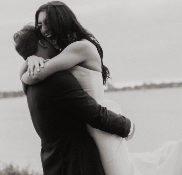 Groom lifting bride as they are taking photos