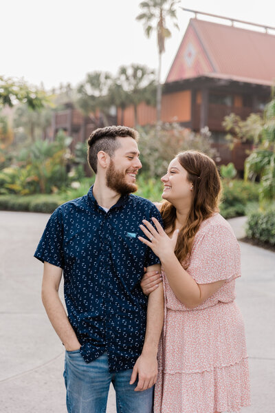 Couple kissing for engagement photo at Disney