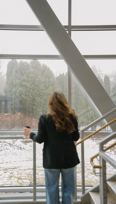 Women social media manager holding coffee and flipping hair