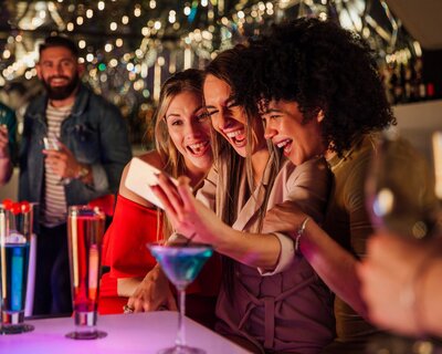 Friends taking a selfie with drinks
