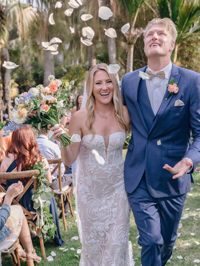 bride and groom under flower petals at santa barbara zoo