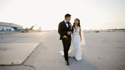A bride and groom pose for a golden hour wedding.