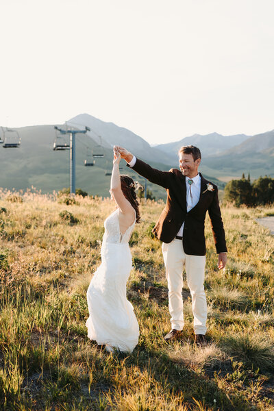 Groom helps bride into jeep in the yankee boy basin in  Ouray, Colorado.