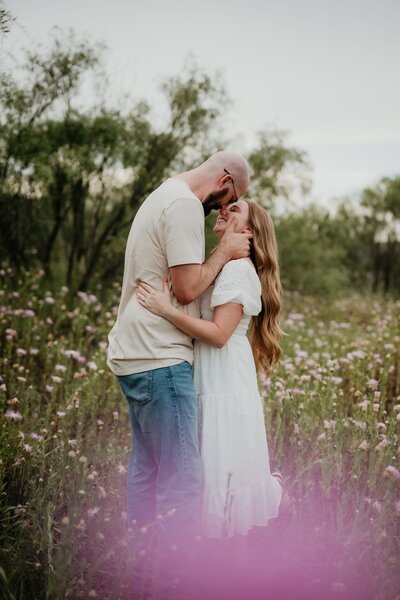 couple embracing in field, palo duro canyon couples session, amarillo texas couples photographer