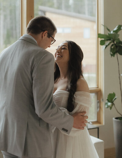 bride and groom smiling and looking at each other in intimate elopement