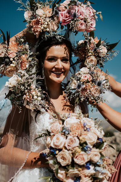 beautiful bride surrounded by bouquets at her Wyoming wedding